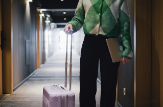 Business Woman Standing in Extended Stay Hallway